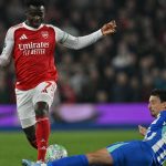 Brighton's French defender #21 Olivier Boscagli (R) tackles Arsenal's English midfielder #07 Bukayo Saka (2L) during the English Premier League football match between Brighton and Hove Albion and Arsenal at the American Express Community Stadium in Brighton, southern England on March 4, 2026.