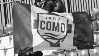 A Como flag is seen at Sinigallia Stadium during the Serie A match between Como 1907 and Atalanta BC in Como, Italy, on February 1, 2026, at Giuseppe Sinigallia Stadium (Photo by Mairo Cinquetti/NurPhoto).
