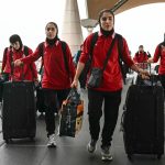 Members of Iran's women's football team arrive at the Kuala Lumpur International Airport in Sepang on March 16, 2026, after staying in a hotel in the Malaysian capital while awaiting the next leg of their journey home. Three more members of the Iranian women's football team have left their asylum in Australia and decided to return home, Canberra said on March 15.