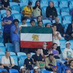 A group of Iranian supporters display a Pahlavi‑era flag during the AFC Women’s Asian Cup Australia 2026 match between Iran and the Philippines on the Gold Coast on March 8, 2026.