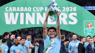 Manchester City's English midfielder #33 Nico O'Reilly poses with the trophy as City players celebrate after the English League Cup final football match between Arsenal and Manchester City at Wembley Stadium in London on March 22, 2026. Nico O'Reilly scored both goals as City won the game 2-0.