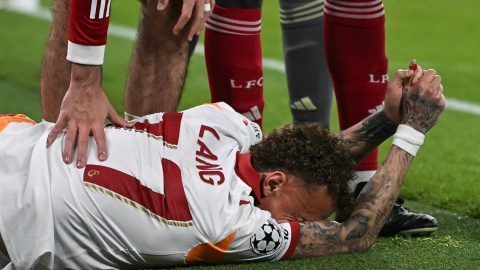 Galatasaray's Dutch forward #77 Noa Lang reacts on the floor after cutting his thumb during the UEFA Champions League, round of 16 second leg football match between Liverpool and Galatasaray at Anfield in Liverpool, north-west England on March 18, 2026.