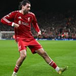 Liverpool's Hungarian midfielder #08 Dominik Szoboszlai celebrates scoring his team's first goal during the UEFA Champions League, round of 16 second leg football match between Liverpool and Galatasaray at Anfield in Liverpool, north-west England on March 18, 2026.