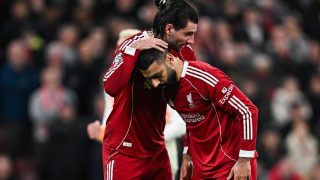 Liverpool's Hungarian midfielder #08 Dominik Szoboszlai (L) greets Liverpool's Egyptian forward #11 Mohamed Salah before a penalty kick during the UEFA Champions League, round of 16 second leg football match between Liverpool and Galatasaray at Anfield in Liverpool, north-west England on March 18, 2026.